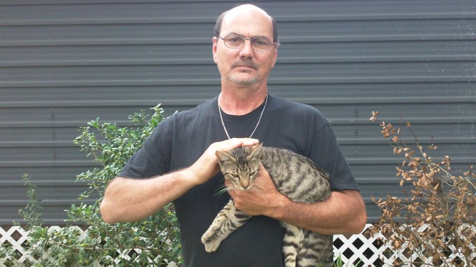 Joe holding a cat